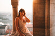 Young Woman in a dress at sunrise in Budapest at the Fisherman's Bastion, Halászbástya