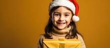 Cheerful Girl In Santa Hat Holds Tablet On Yellow Background