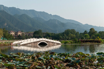 Wall Mural - Stone arch bridge on the lake，Beautiful Longshui Lake Wetland Park, Chongqing, China