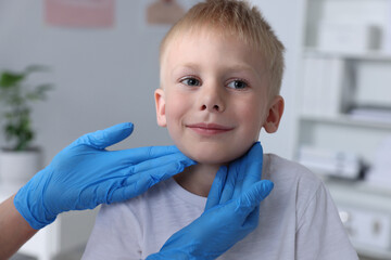 Wall Mural - Endocrinologist examining boy's thyroid gland indoors, closeup