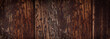 Horizontal background of old dark wooden planks. Weathered wooden structure.