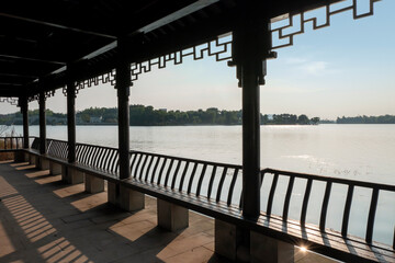 Wall Mural - The long corridor by the lake in the park