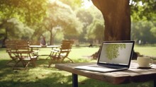 A Person Working On A Laptop In A Park Picnic Workspace.