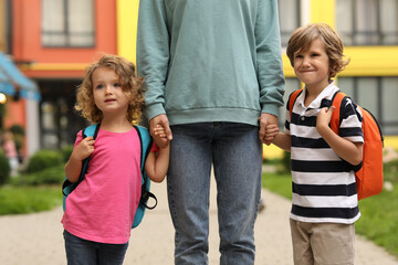 Sticker - Woman and her children on their way to kindergarten outdoors