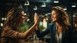 © Amonthep - Successful business people giving each other high five in a meeting,colleagues sharing joy of achievement.happy businesswomen giving high five celebrating business success together in coworking space