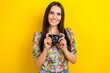 © deagreez - Photo of toothy beaming cute girl with long hair dressed flower print blouse arms holding camera isolated on yellow color background