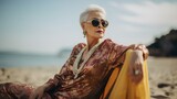 Fototapeta  - a grandmother in a kebaya who is relaxing on the beach wearing glasses 