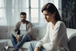 © Konstiantyn Zap - Relationship woes: depressed man and woman on a sofa, illustrating a couple's conflict, communication breakdown, and emotional distress