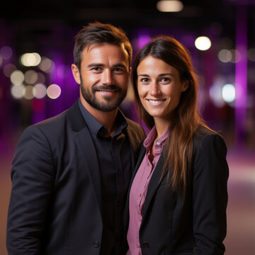 a man and a woman are standing at full height, there is a purple glow around them, the background is empty and black, they are looking at the camera 
