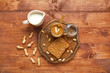 Board of toast with peanut butter and nuts on wooden background