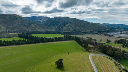 Wall Mural - The blue water of the Awatere river flowing through agricultural farmland in a rural valley