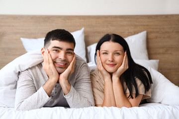 Poster - Young couple lying in bedroom