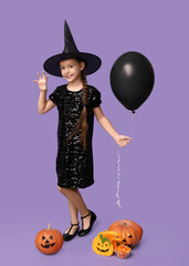 Sticker - Cute little girl dressed for Halloween as witch with pumpkins, bag, balloon and candies on purple background