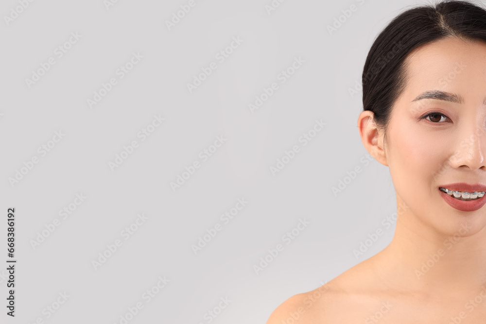 Beautiful Asian woman on light background, closeup