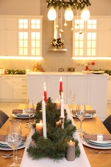 Poster - Festive table setting and beautiful Christmas decor in kitchen. Interior design