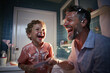father and son happily playing with shaving foam