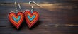 Heart shaped earring with colorful embroidery woven thread on vintage wood texture