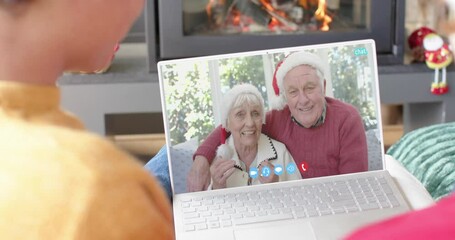 Poster - Happy caucasian couple and senior parents having christmas laptop video call, slow motion