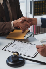 Lawyers shake hands with business people to seal a deal with partner lawyers or a lawyer discussing contract agreements, handshake concepts, agreements.