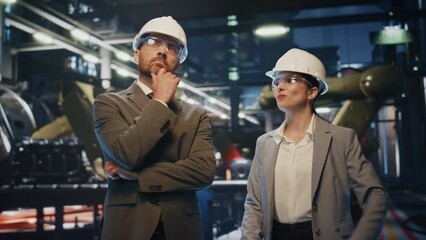 Canvas Print - Production owners inspect factory premises in protective helmets close up.