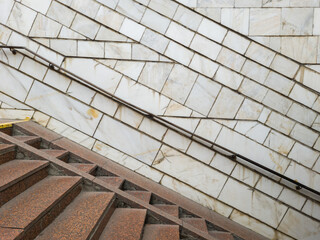 Wall Mural - stairs to the underpass or subway station. side view of empty stairs with a wall lined with marble a