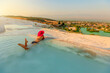 tourist woman finds a moment of tranquility as she submerges herself in pristine waters of Turkey's natural pools at Pamukkale. Surrounded by stunning white terraces, creating a surreal atmosphere.
