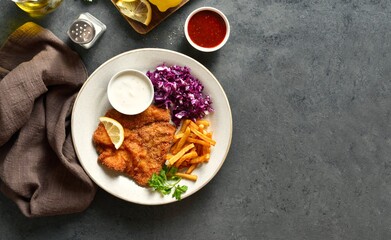 Wall Mural - Schnitzel with potato fries, cabbage salad and sauce