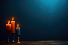 Burning Candles In Candlestick On Wooden Table On Dark Blue Background. High Quality Photo