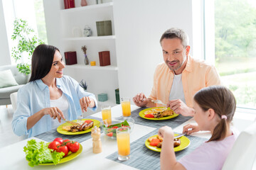 Wall Mural - Photo of cheerful idyllic people good mood enjoy eat tasty food together kitchen table apartment inside