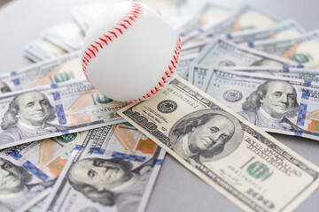 Baseball ball with cash money. Major league strike, lockout and sports betting concept.