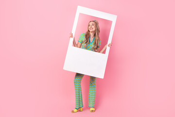 Wall Mural - Full length photo of lovely young lady photo frame interested look dressed stylish green print garment isolated on pink color background