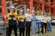 © Nassorn - Diverse group of warehouse workers standing at storehouse with team, portrait. Multicultural men and women working together at cargo factory. Latino, Hispanic, Caucasian, Asian people teamwork concept