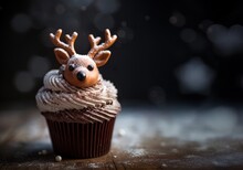 Cupcake With Chocolate Reindeer With Antlers Decoration. Winter, Seasonal Muffin With Deer Face In Sugar Or Chocolate. Festive Food, Treat For Holiday Celebration.