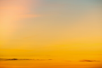 Wall Mural - The dramatic colors of the sunset in the sky gradient from blue to orange.