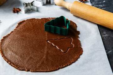 Wall Mural - baking, cooking and christmas concept - close up of gingerbread dough, cookies molds and rolling pin on kitchen table