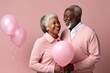 Senior afro couple holding pink balloon. AI Generated.