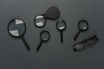 Wall Mural - Magnifiers with eyeglasses on a dark gray background