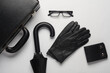 Leather suitcase with gloves, purse, eyeglasses on white background. Business concept. Top view. Flat lay