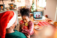 An African-American father surprises his daughter with a Christmas gift