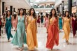 Group of women walking in a shopping mall wearing long luxurious flowing dresses in orange and turquoise colors