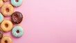 Some donut on the left, light pink background, with copy space top view. Delicious glazed donuts on white background, flat lay. Space for text Generative AI