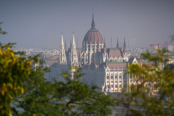 Wall Mural - Hungarian Parliament building. View from above over the Budapest Parliament landmark construction, next to Danube river, during a foggy summer morning. Travel to Hungary.