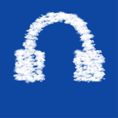 Poster - Clouds in the shape of a headphones symbol on a blue sky background. A symbol consisting of clouds in the center. Vector illustration on blue background