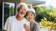 © JW Studio - outdoor portrait of happy senior asian couple, outside of home yard, with copy space.