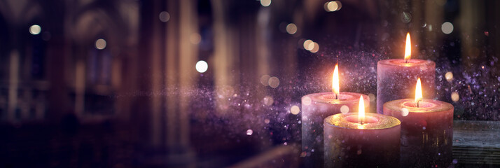 Wall Mural - advent candles burning in the dark with glitter on flames and abstract defocused lights
