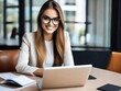 © Евгений Порохин - a young smiling beautiful woman is working at a laptop in the office