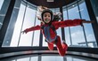 Free falling of a child girl in a simulator at a city skydiving center