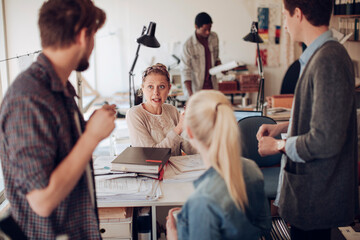 Wall Mural - Young and diverse group of architects working on a project together in a startup company office