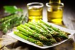 closeup of asparagus tips glistening with olive oil