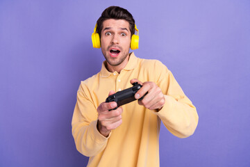 Aufkleber - Photo of good mood impressed guy wear yellow shirt earphones loosing playstation game isolated violet color background